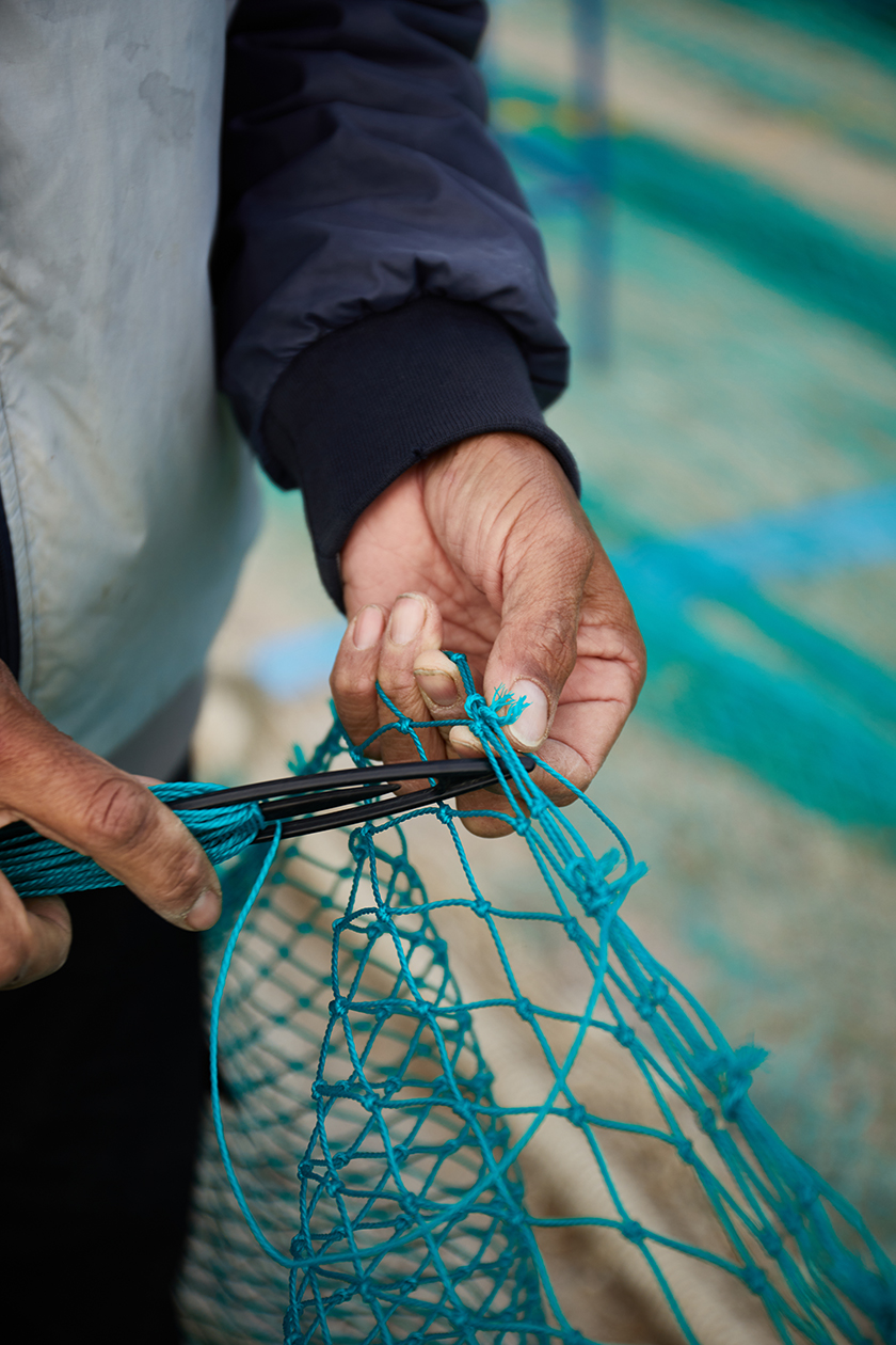 Fisherman cutting the nets for fishing