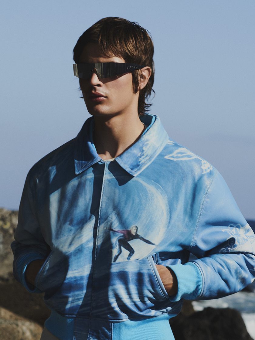 Model with sunglasses and a blue jacket in Tenerife for the Harvey Nichols shopping centre summer campaign
