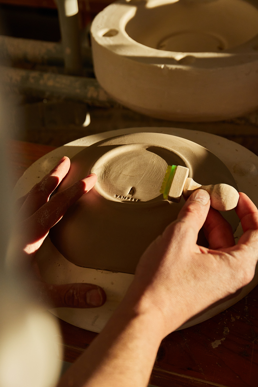 Hands making pottery on a potter's wheel Catalunya x Conde Nast Traveler magazine. 