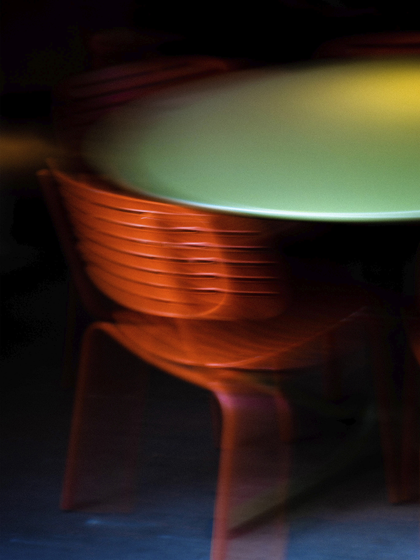 Blurred image of a red chair in a bar, the contrasting colours stand out very much for the Bar Viu exhibition. 