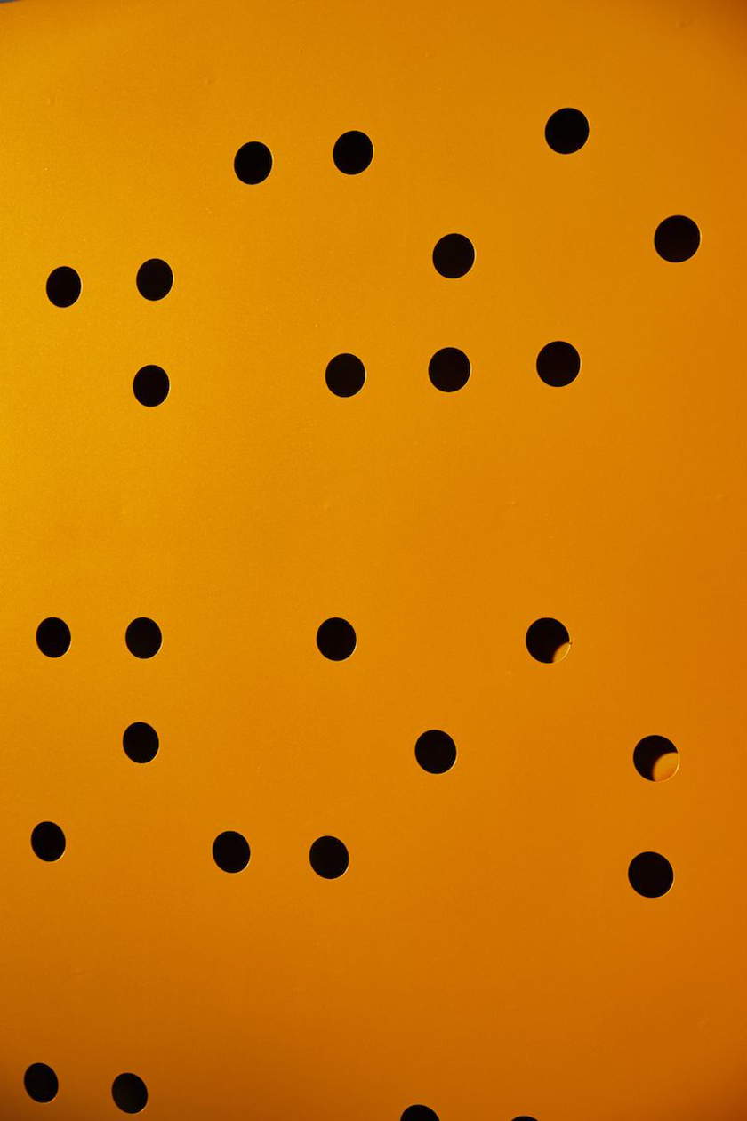 Black dots on a yellow background caused by sunlight.