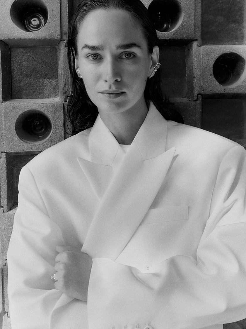 Black and white image of the model wearing the earrings from the new campaign. 