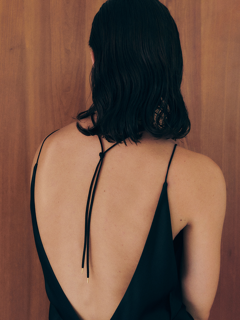 Shot form the back of the model with the new collection of neckless from Prunés Jewellery campaign. 