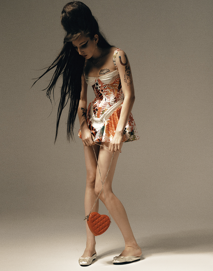 Model posing in a short dress in homage to Amy Winehouse