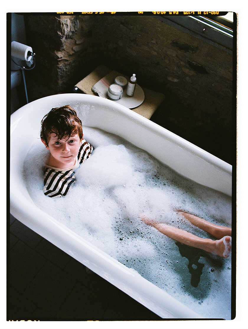 Child in a bathtub with lots of foam. 