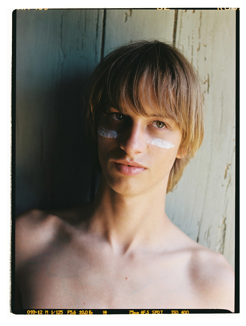 Image of a boy in profile with cream Midnight 00.00 under his eyes. 