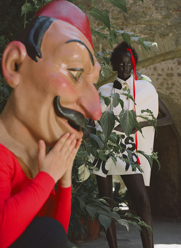 In the foreground, a flat capgross doll typical of Catalan culture with the model in the background for the magazine Numéro Netherlands. 