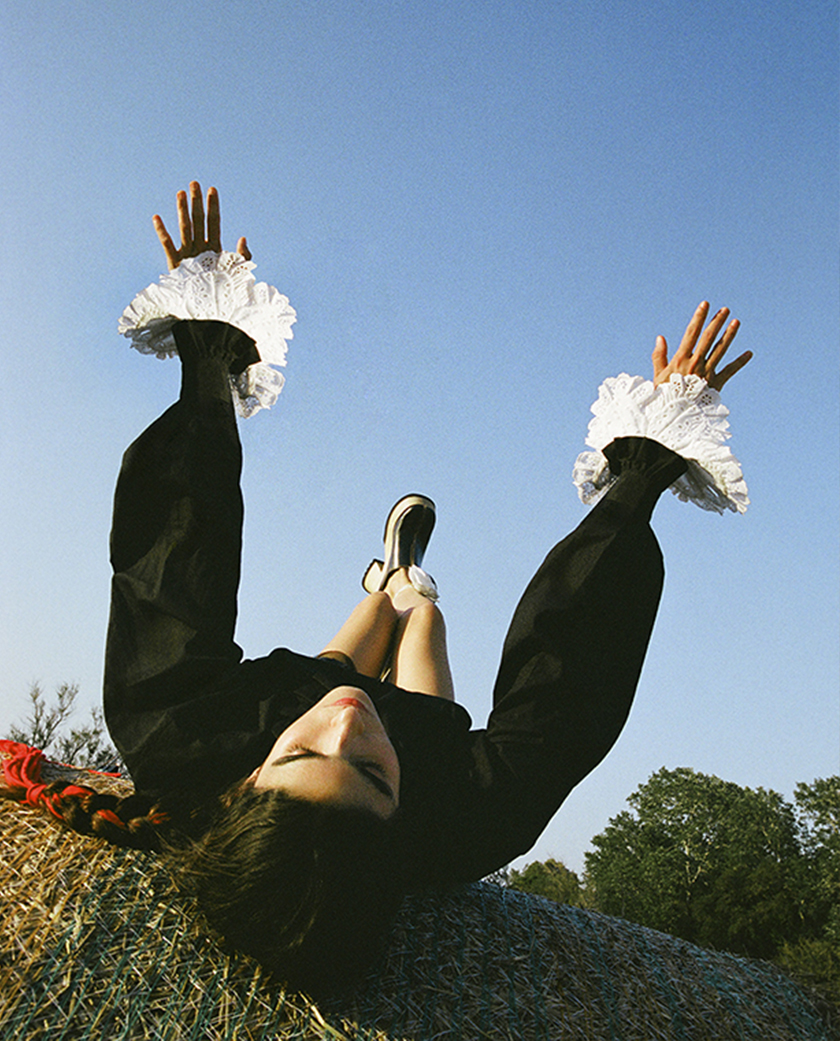 Face-up model stretched out on a bale of straw for the magazine Numéro Netherlands. 