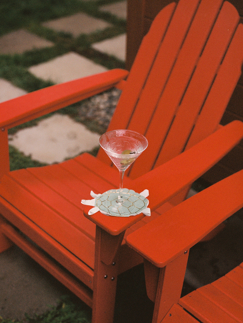 iamge of red chairs with a turtle-shaped cup holder for Condé Nast Traveller Spain magazine. 