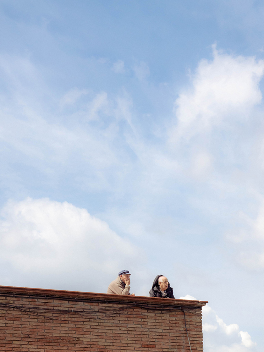 people watching the passage from the rooftop of a building