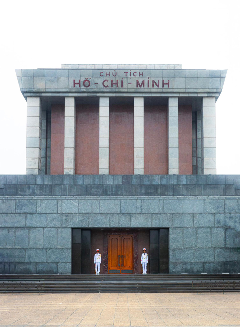 government building in vietnam with two gaurdais guarding the front door