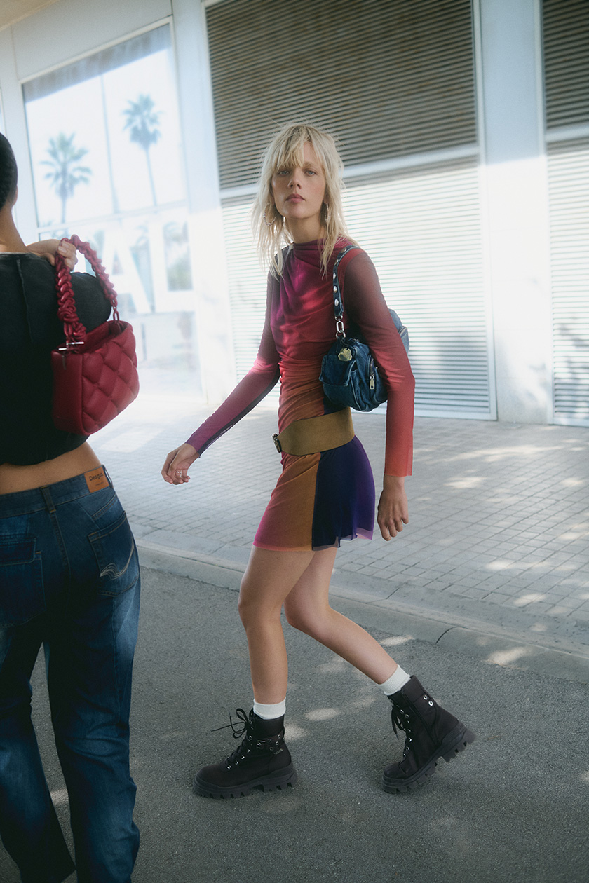 Two models walking through the streets of Barcelona with two colourful looks form Desigual winter collection. 