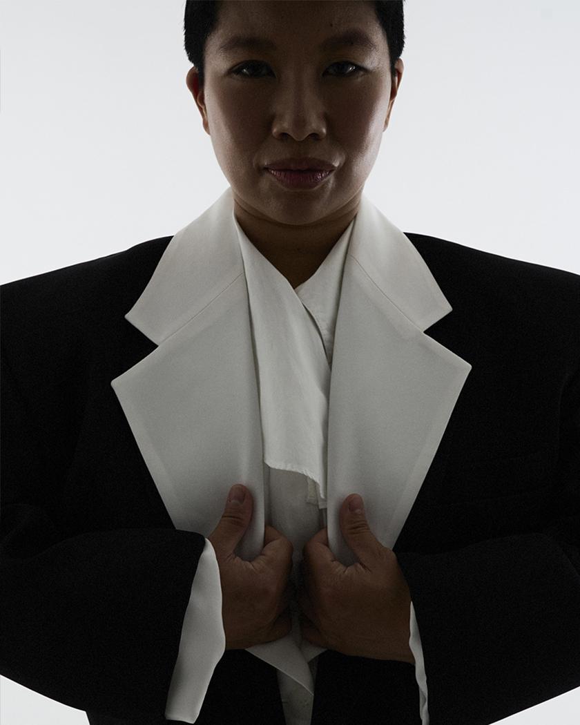 Short shot of Sophia Wang in a black and white suit.