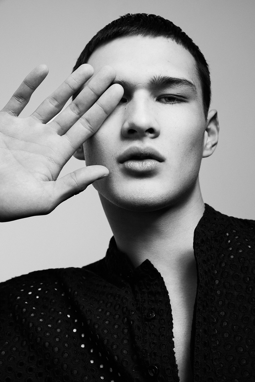Cover for The Perfect Man magazine in black and white of an asian model covering half of his face with his hand.
